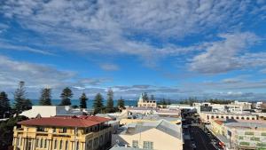 a city with buildings and a blue sky with clouds at 2 Bed Apartment-Panoramic Views in Napier +3 photos