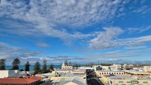 a city with buildings and a blue sky with clouds at 2 Bed Apartment-Panoramic Views in Napier
