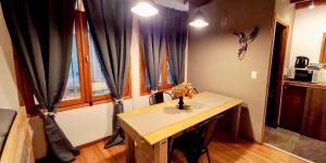 a room with a table and a window with curtains at ORIGEN Centro in El Bolsón