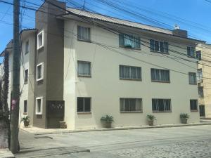a white building with plants in front of it at Acogedor apartamento minimalista Mai in Puerto Vallarta