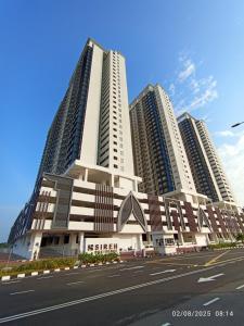 a large building with tall buildings in the background at SR Sireh Residence in Kota Bharu