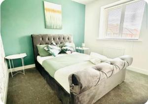 a bedroom with a bed with a tufted headboard at Maize Walk Retreat - Ashford Beauty in Ashford