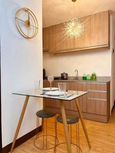 a kitchen with a table and stools in a kitchen at Arezzo en Grande in Davao City