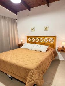 a bedroom with a large bed in a room at Cabaña YMBYATY in Colonia Carlos Pellegrini