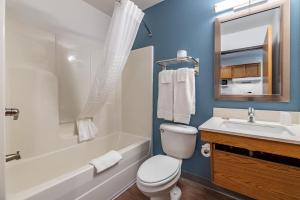 a bathroom with a white toilet and a sink at Extended Stay America Select Suites - Ocala in Ocala +27 photos