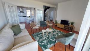 a living room with a couch and chairs and a table at SEA VIEW HOUSE - inpico in Santo António