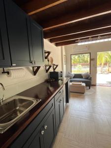 a kitchen with a sink and a living room at Phimai Pond House in Pi Mai +45 photos