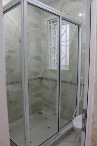 a glass shower in a bathroom with a toilet at Hoang Thanh Thuy 3 Hotel in Ho Coc