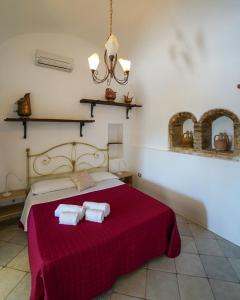 a bedroom with a bed with two towels on it at Tenuta San Tommaso in Pisticci +30 photos
