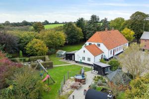 an aerial view of a white house with a playground at 580 M2 Countryside Idyll With Activity Room in Haderslev