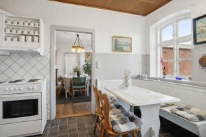 a kitchen with a table and a dining room at 580 M2 Countryside Idyll With Activity Room in Haderslev +31 photos