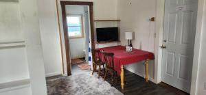 a room with a red table with chairs and a television at The Seneca Sunset Suites in Burdett +8 photos