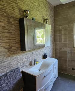 a bathroom with a white sink and a mirror at Appartement Güstrow "free energy from solar Panels" in Lomé +20 photos