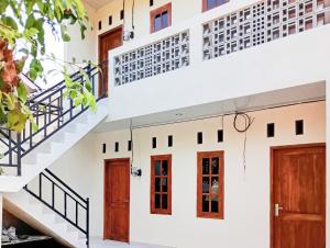 a group of doors and stairs in a building at Danesty Homestay Sedayu near Universitas Mercu Buana Yogyakarta RedPartner in Pedes