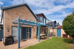 a house with a deck and a patio at Tresco, Town central-beach end in Dunsborough