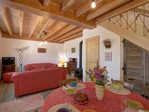 un soggiorno con divano rosso e tavolo rosso di Gîte 4 pers, terrasse & jardin, près des Bois Noirs - FR-1-496-348 a Saint-Priest-la-Prugne