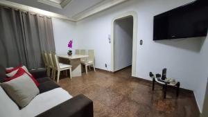 a living room with a couch and a table at Praia do Forte Cabo Frio - Apto Beira Mar in Cabo Frio