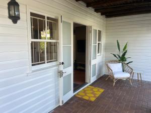 an entrance to a house with a door and a chair at Windsor Retreat City Views - Garden Suite in Brisbane