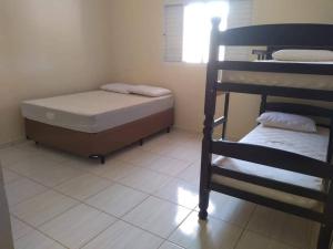 a small room with a bed and a bunk bed at Recanto Julia in Olímpia +15 photos