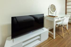 TV a/nebo společenská místnost v ubytování 潤 伊藤ビル