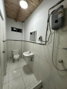 a bathroom with a toilet and a shower and a sink at Casa de campo relax y piscina in Cerro Azul