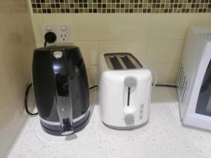 two toasters sitting on a counter next to a toaster at Room Close Melbourne Airport in Melbourne