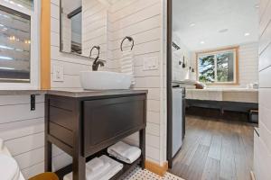 a bathroom with a sink and a mirror at Eco Friendly Tiny Container Home Retreat in Camas