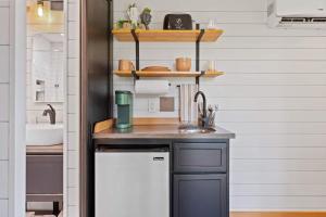 a kitchen with a sink and a counter top at Eco Friendly Tiny Container Home Retreat in Camas