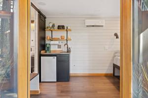a kitchen with a white refrigerator and a counter at Eco Friendly Tiny Container Home Retreat in Camas +53 photos