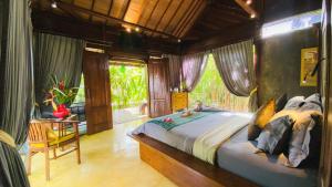 a bedroom with a large bed in a room at Maso Christian Villa in Tumbak Bayuh