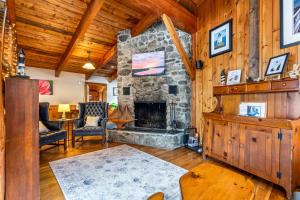 a living room with a stone fireplace at Bluff House Inn in Gouldsboro