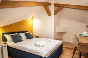 a bedroom with a bed with two towels on it at Volotel SkyWay in Cluj-Napoca