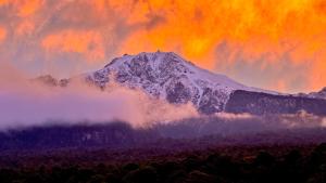 a mountain covered in snow and clouds in front at Cámping Cuamanco in Huamantla