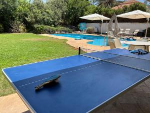 a ping pong table in front of a swimming pool at Sunny Coastal villa, luxury gateway! in Caesarea