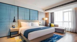 Postel nebo postele na pokoji v ubytování Echarm Hotel Torch Development Zone Zhongshan Station