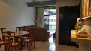 a kitchen and dining room with a table and chairs at Tulip Hotel in Ipoh
