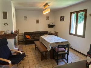 a living room with a table and a couch at Maison de Vacances in Pradelles-Cabardès