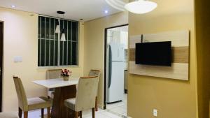 a kitchen with a table and a refrigerator at GUARÁS - Complete & excellent locationCOP 30 in Belém