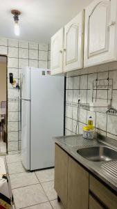 a kitchen with white cabinets and a white refrigerator at GUARÁS - Complete & excellent locationCOP 30 in Belém