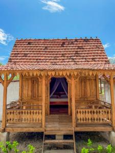 a wooden gazebo with a bed in it at Mimpi Bungalow in Gili Meno