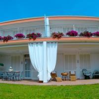 a building with a large white curtain in front of it at Villa Regina B&B in Nettuno