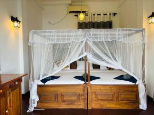 a bedroom with a bed with a canopy at Belmount Ella in Ella