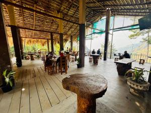 a restaurant with a table and people sitting at tables at Belmount Ella in Ella