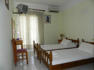 Posteľ alebo postele v izbe v ubytovaní Logara's Apartments