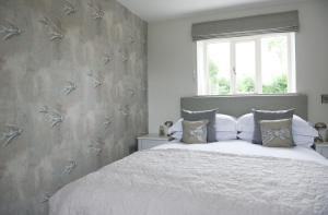 a bedroom with a large bed and a window at Cromhall Farm in Chippenham