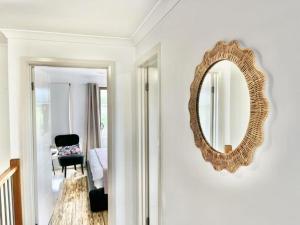 a mirror on a wall in a room with a chair at Room Close Melbourne Airport in Melbourne