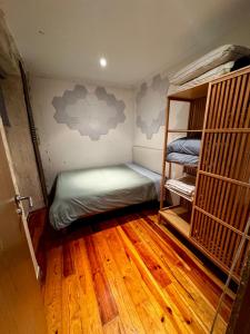 a room with two bunk beds and a wooden floor at historic hearth of Bairro Alto in Lisbon