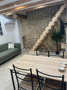 a living room with a wooden table and chairs at L escale des dhuys in Soulaines-Dhuys +12 photos