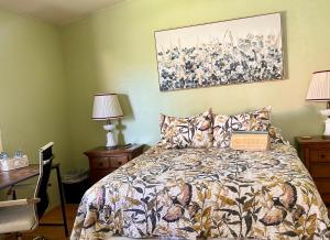 a bedroom with a bed and a painting on the wall at Meadow Harvest Suite with TV and private bathroom in Hemet +49 photos