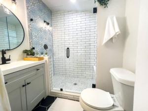 a bathroom with a shower and a toilet and a sink at Cozy Home In Tampa Near Ybor & Busch Gardens in Tampa +33 photos